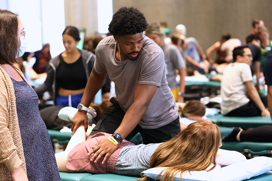 DPT student practicing a technique on another student in lab