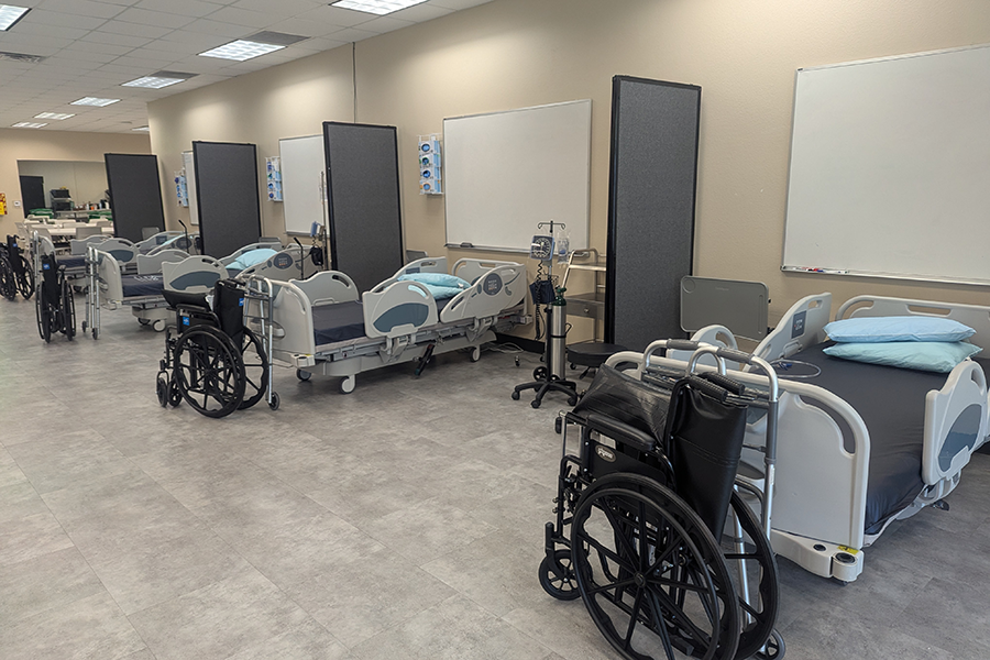 Rows of hospital beds and rehabilitation equipment in Student Life Center