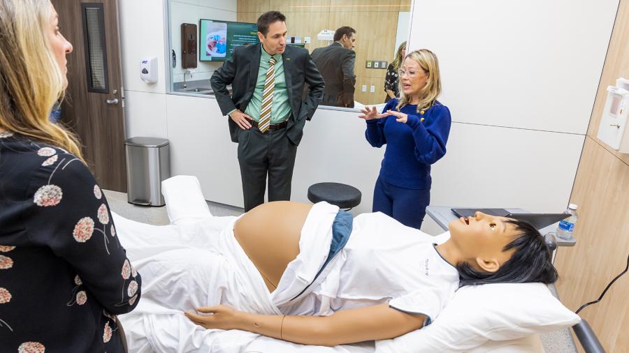 Faculty learn about a high-fidelity manikin that can simulate pregnancy. 